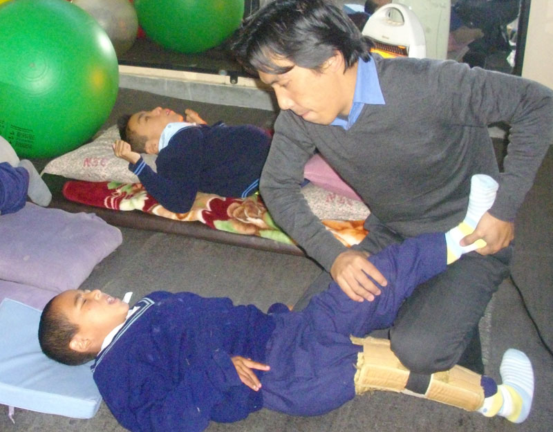 Physiotherapist treating one of Ngoenga's young pupils